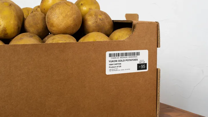 Cardboard box of potatoes with thermal barcode label