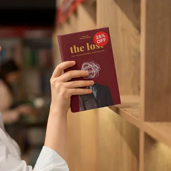 Hand pulling a book off of a shelf