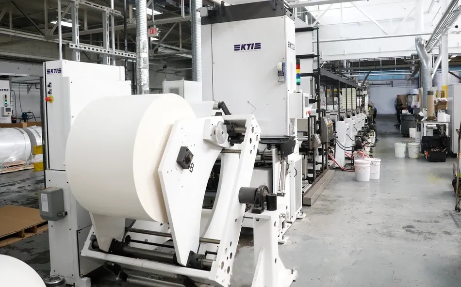 Manufacturing floor with equipment and workers in solvent-free environment