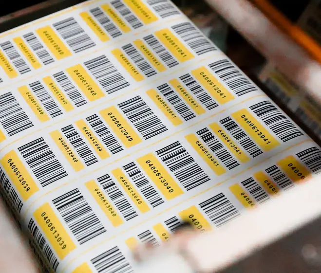 a web of barcode labels flowing through a machine