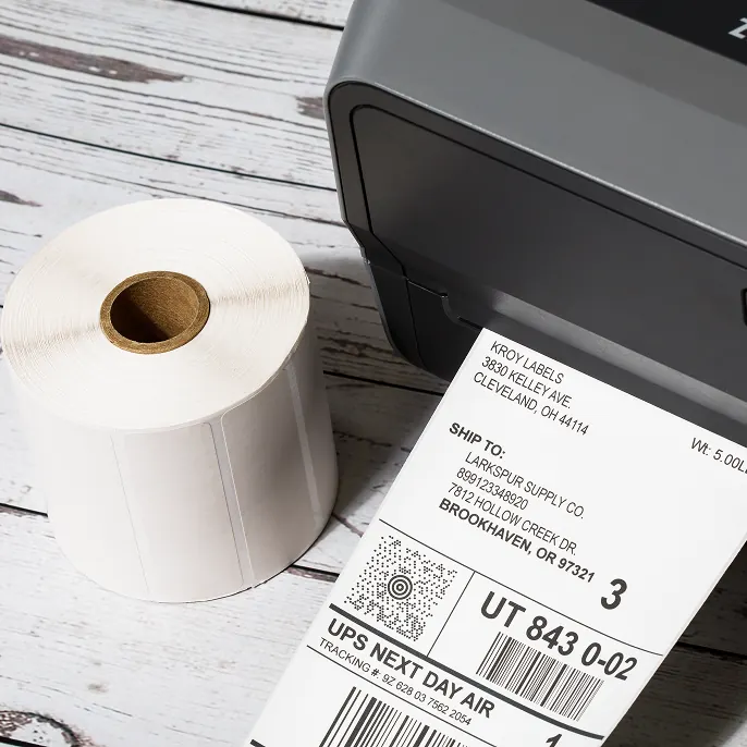 Orange LPN barcode label on cardboard box with hand holding it