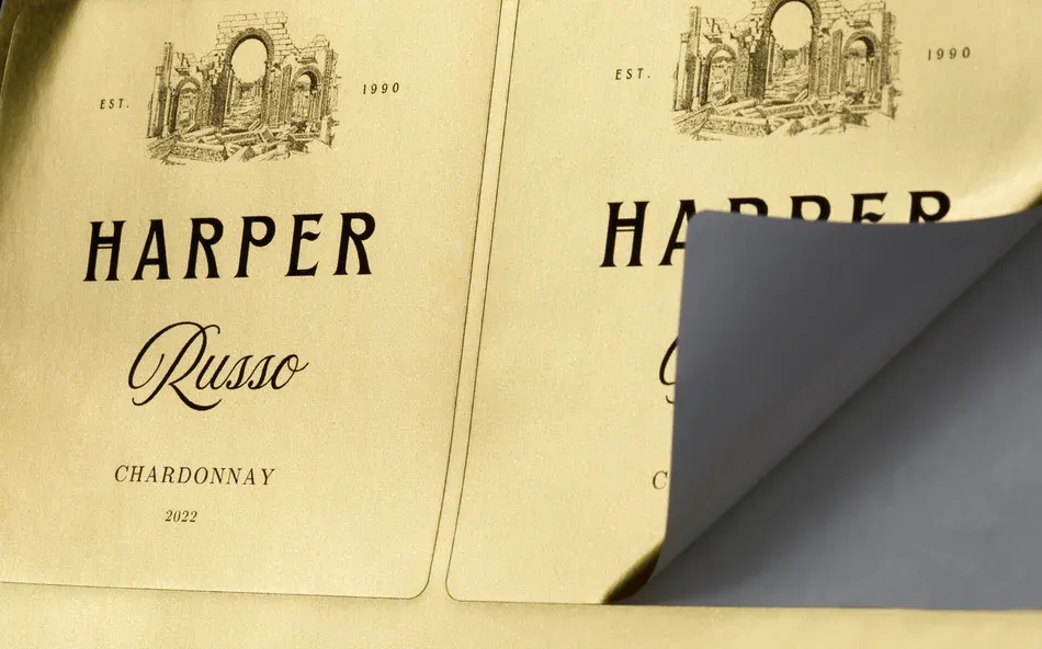 a sheet label being peeled off of a sheet of others