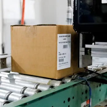 labeled cardboard box on a conveyor belt