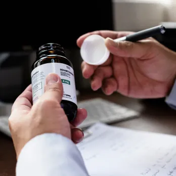 Medical professional holding specimen tube with label