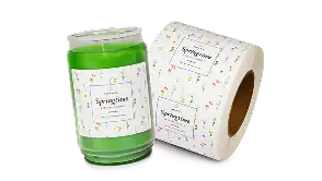 Custom honey jar label next to roll of colorful digitally printed product labels