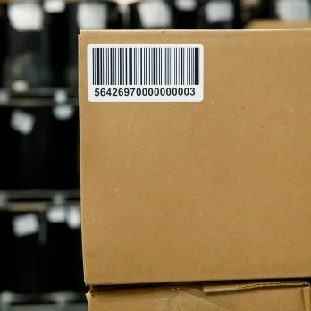 Cardboard package with barcode shipping label showing tracking information