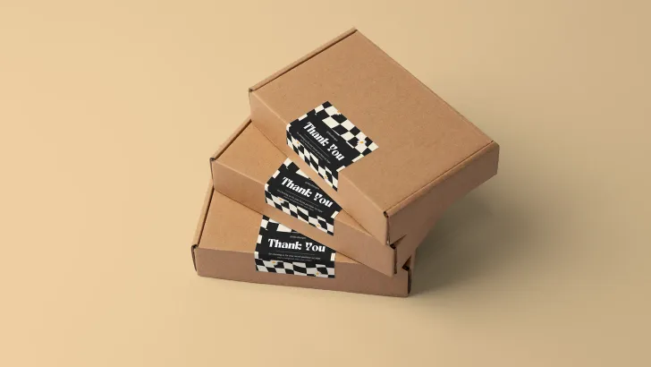 Cardboard boxes with custom-printed digital labels featuring geometric pattern design