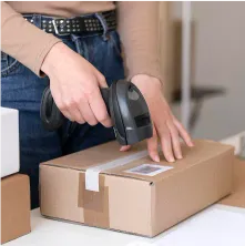 someone using a hand scanner on a labeled cardboard box