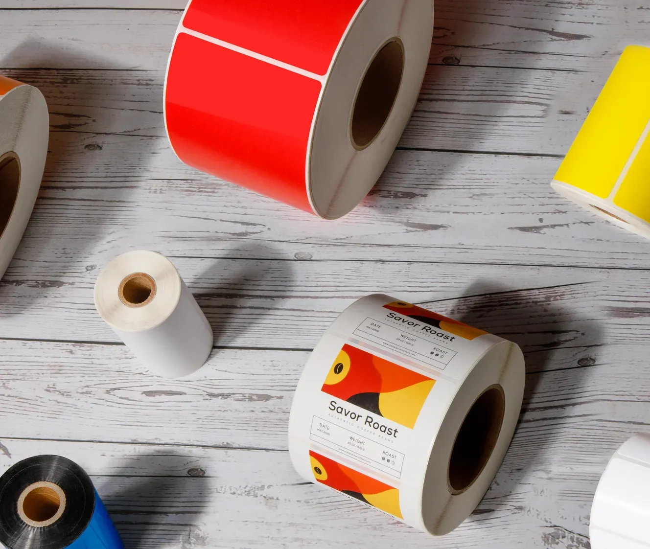 Various colorful label rolls and thermal transfer ribbons showcasing our product offerings
