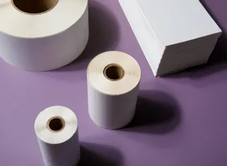 several rolls of labels and a stack of fanfold labels