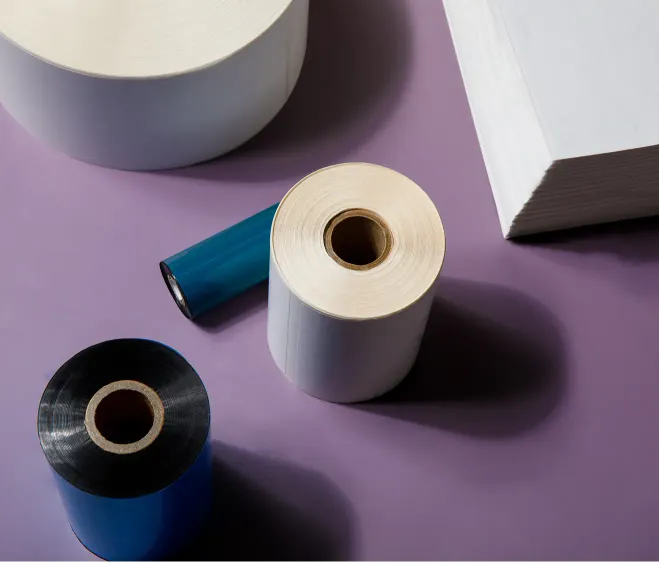 several roll of labels and a stack of fanfold labels