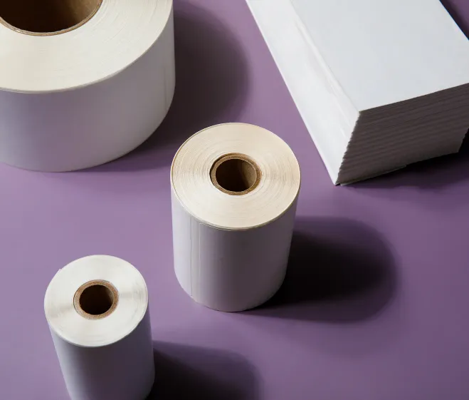 several rolls of labels and a stack of fanfold labels