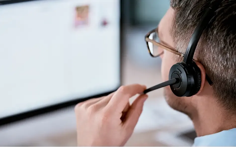 a team member wearing a headset, talking to a customer