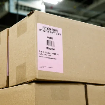 Pink shipping label on kraft paper package