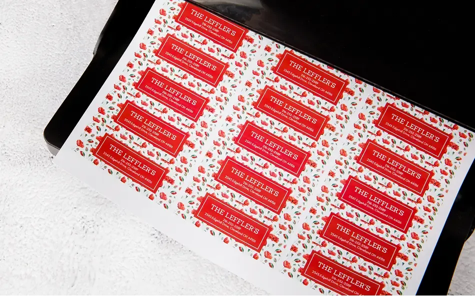 a sheet of labels coming out of a printer