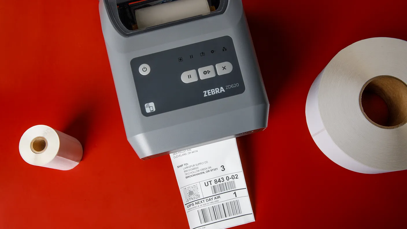 a zebra printer with rolls of thermal labels on either side