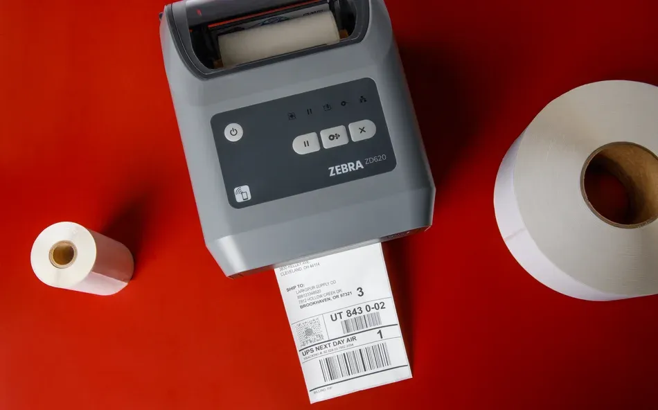 Red thermal transfer printer with printed label on red surface