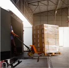a fork lift in front of a pallet of boxes