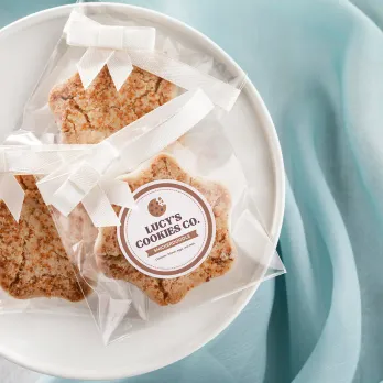 Artisan cookies with brand label on white plate
