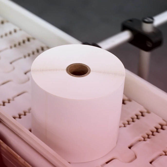 a huge roll of paper on a machine in a factory